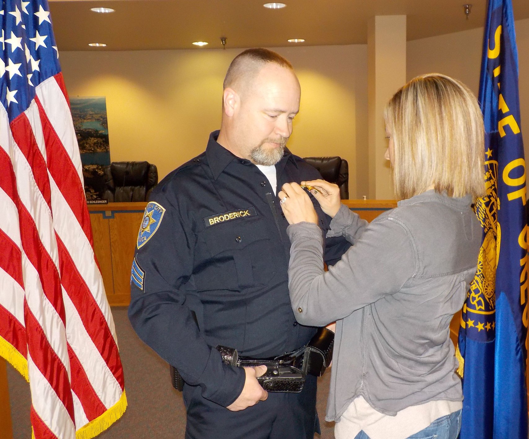 Sgt. Broderick receiving his badge from his wife Kristen.