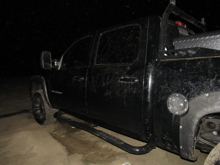 Man abandons beached, swamped truck; flees scene on foot