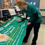 Wilson signs banner