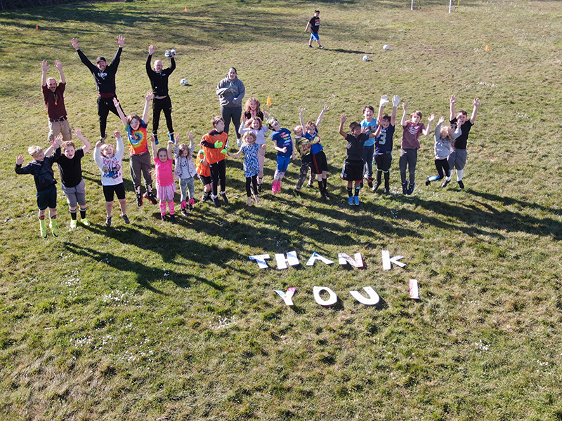 Soccer players and coaches thanking Rep. Gomberg